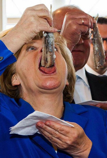 Angela Merkel eating herring