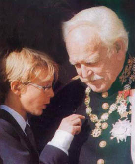 Prince Rainier of Monaco admiring the military honors of his granfather