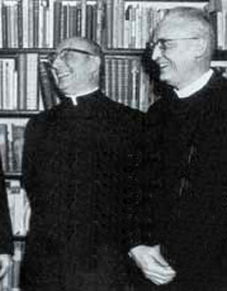 A black and white photograph of Fr. Diekmann laughing with members of the theological committee