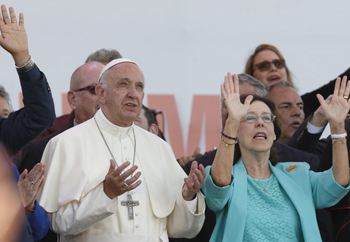 francis holding his hands up at a pentecost vigil