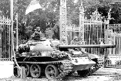A communist tank crashes through the gates of the Presidential palace