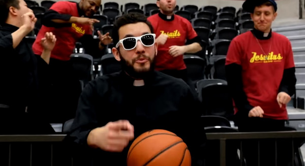 A Jesuit priest in sunglasses holding a basketball