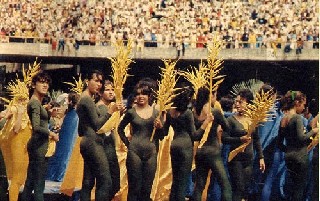 Young women in immodest leotards prepare to perform for the Pope