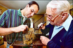 A young man learning Watchmaking from his grandfather