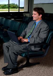 A dignified young man waiting in an airport