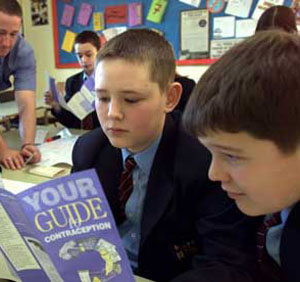 Boys reading books on sex education in a Catholic School