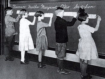 A black and white photograph of students learning cursive with the Palmer method