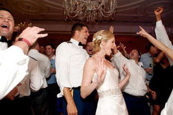 immodestly dressed men and women dancing to modern music at a wedding reception
