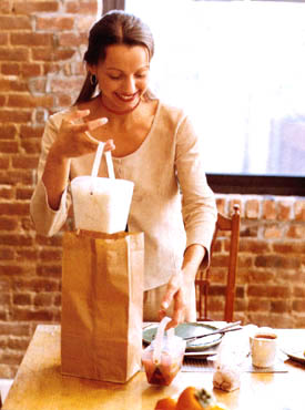 A woman arranging take out at a dinner table