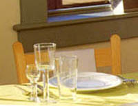 A table setting of a plate with glasses