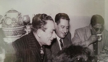 black and white photograph of men enjoying coffee