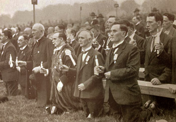 Black and white photograph of men in formal attire holding candles at the Irish Eucharistic Congress of 1932