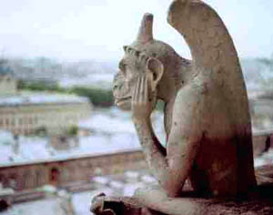 A contemplative gargoyle atop Notre Dame Cathedral