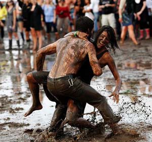 A young man and woman mud wrestling at Woodstock 2002