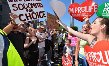 Irish homosexual sodomites protesting in favor of Abortion against pro-lifers