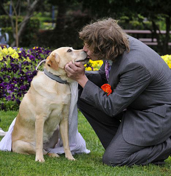man kissing and marrying his dog