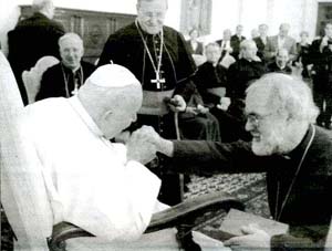 John Paul II kissing the hand of Rowan William