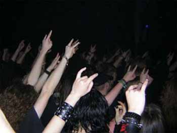 Satanic hand symbols at a rock party