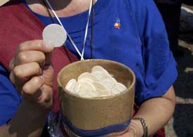 Communion distributed by a lay woman