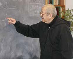 An elderly brother Francis lecturing on mathematics