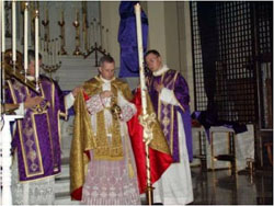 Photograph of a traditional priest incensing the easter candle