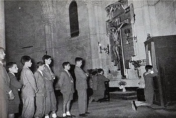 Black and White photograph of youths lining up for confession