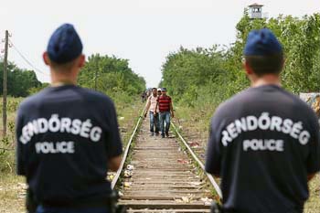 Hungarian border police stopping migrants