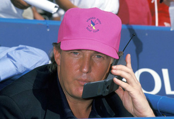 Donald Trump wearing a pink cap talking on a primitive cell phone