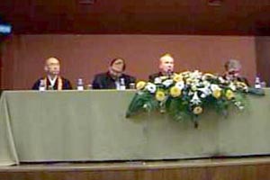 Archbishop Fitzgerald sits with a Buddhist, a Hindu, and a Muslim