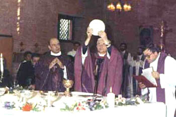 A priest consecrating a huge host