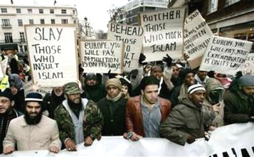 Muslims carrying violent signs