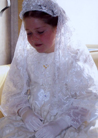 A girl in a beautiful modest first communion dress