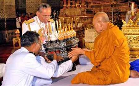 A Buddhist monk receiving a gift from the king of Thailand