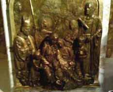 A bronze relief detail showing Bishop weakland in the Biblical protection of children