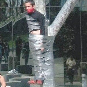 a man taped to a tree