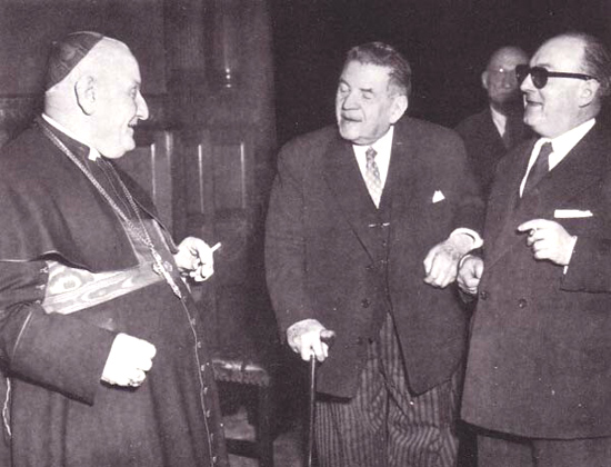 an aged photograph showing Angelo Roncalli smoking a cigarette with lay friends