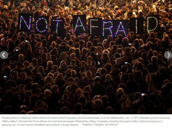 A crowd holding up a sign that reads; Not Afraid