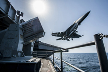 a fighter jet taking off from an aircraft carrier