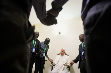 Pope Francis holding hands with African Jesuits
