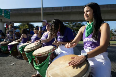 Feminists playing native drums