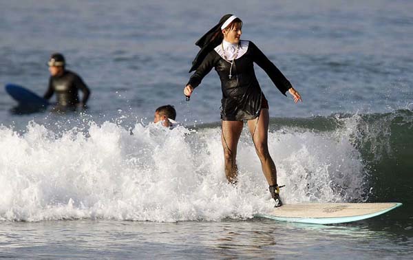 nun surfing on a surfboard