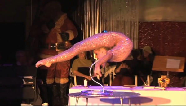 An immorally dressed acrobat performing in front of an altar
