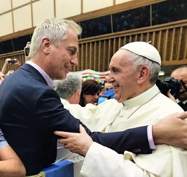 Alejandro Wiebe Marley embracing a smiling Pope Francis