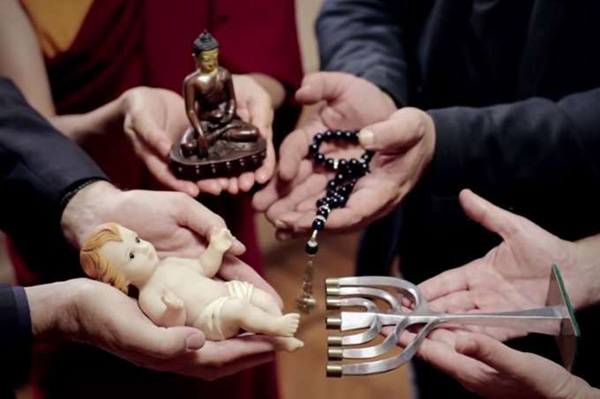 Religious persons holding symbols of Christianity, Judaism, Islam, and Buddhism