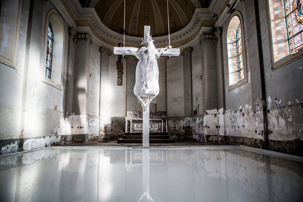 A crucified corpse of a cow over a pool of milk in the St. John Baptist Church of Kuttekoven
