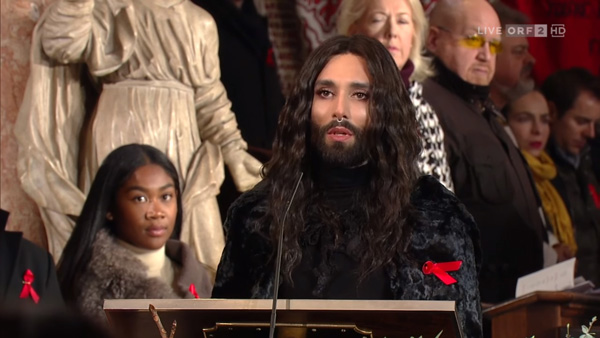 Conchita Wurz giving a speech at a podium in the Cathedral of Vienna