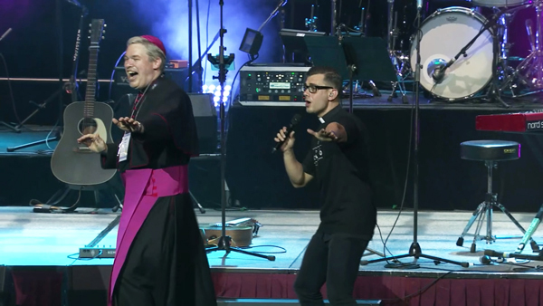 Bishop Richard Umbers and Fr. Robert Galea sisinging pop music on stage at Australia Youth Day 2017