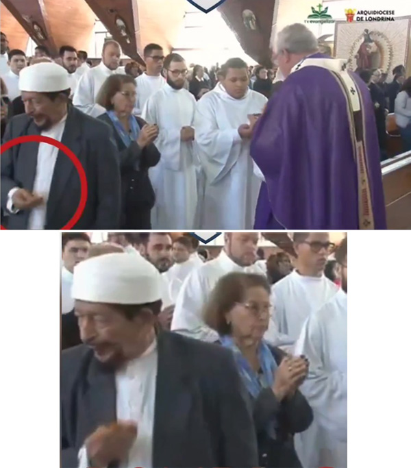 Archbishop Geremnias Steinmetz gives communion to Sheikh Mahairi 2