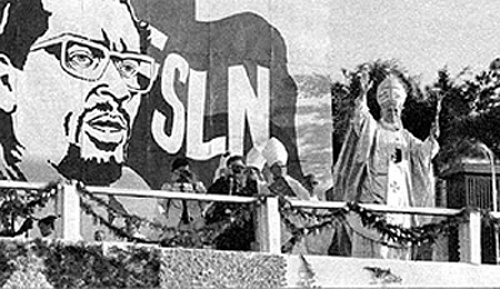 John Paul II in front of a billboard of Augusto Sandino and Carlos Fonseca