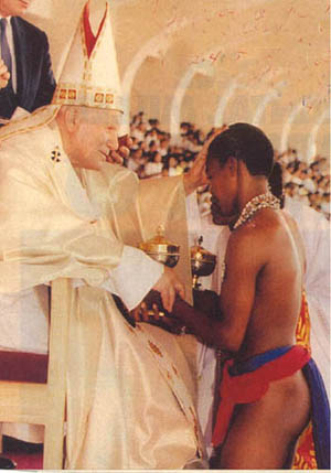 John Paul II receiving chalices from semi-naked native youths
